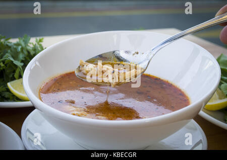 Hühnersuppe mit Nudeln und Gemüse, die in weiße Schüssel Stockfoto