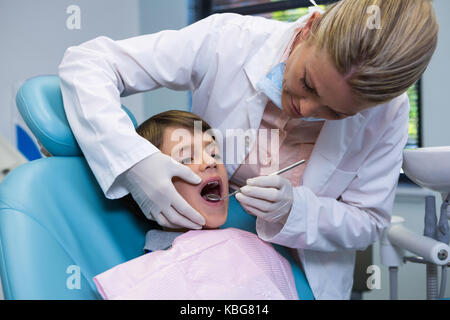 Zahnarzt holding Ausrüstung, bei der Junge an der Medizinischen Klinik Stockfoto