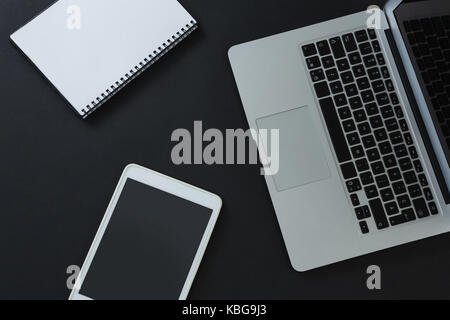 Overhead von Notebook, digitale Tablet und Veranstalter auf schwarzem Hintergrund Stockfoto