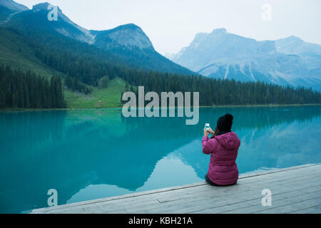 Rückansicht der Frau ein Bild mit seinem Handy in der Landschaft Stockfoto