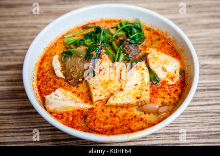 Eine Schüssel von Singapur Laksa Yong Tau Foo, eine populäre lokale Gericht in pikanter Soße serviert curry Garnelenpaste Suppe mit Kokosmilch; Tofu und Aubergine f Stockfoto