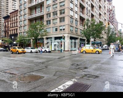 New York City, NY, USA, Street Scene. Kreuzung 3rd Avenue, East 87th Street nach dem Regen mit Menschen überqueren die Straße, Reihe Yellow Cabs minimaler Verkehr. Stockfoto