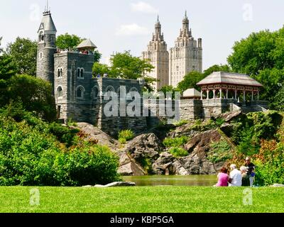 Reife Erwachsene am Rand des Central Park Schildkröte Teich entspannen, Besucher mit Blick auf Park von der Oberseite des Schloss Belvedere, Spätsommer, New York City, NY, USA. Stockfoto