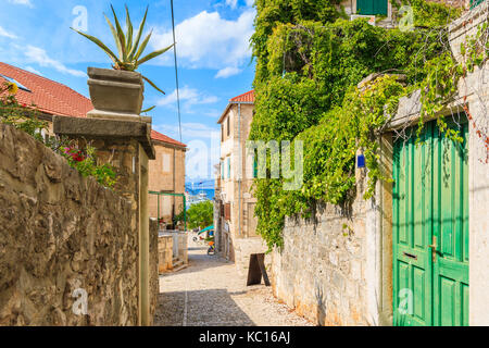 Schmale Straße zum Hafen in der Altstadt von Postira, Insel Brac, Kroatien Stockfoto