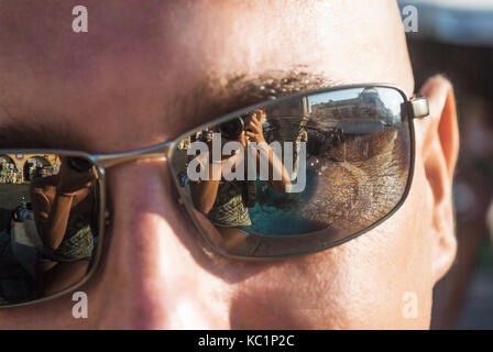 Nahaufnahme der Sonnenbrille, das Gesicht des Mannes, der reflektiert wird, Mädchen, selbst fotografiert. Stockfoto