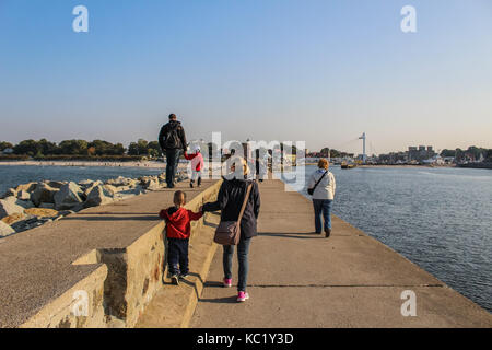 Ustka, Polen. 30 Sep, 2017. Menschen walkin und Sonnenbaden an den Ustka Pier und Wellenbrecher sind in Ustka gesehen, am 30. September 2017. Die Menschen genießen Sie sonnige und warme Herbst Wetter mit Temperaturen von 20 Grad Celsius. Quelle: Michal Fludra/Alamy leben Nachrichten Stockfoto