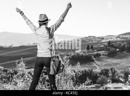 Entdecken Sie magische Ausblicke der Toskana. Von hinten aktive Frau Wanderer in hat Wandern in der Toskana gesehen Freude Stockfoto