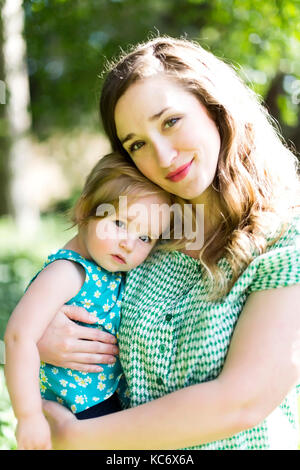Portrait von Mutter und Baby girl (12-17 Monate) im Hinterhof Stockfoto