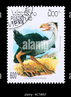 Briefmarke aus Laos mit der Darstellung eines Phorusrhacos Stockfoto