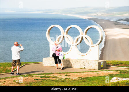 Isle of Portland, Großbritannien. 3. Okt 2017. UK Wetter. Ein älteres Paar Fotos an der 2012 Olympischen Ringe auf Portland, mit Blick auf Chesil Beach, nach schweren nächtlichen Regen Credit: stuart Hartmut Ost/Alamy leben Nachrichten Stockfoto