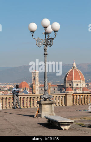 FLORENZ, ITALIEN, 12. September 2015 : kleine Geschenke und Souvenirverkäufer vor dem Stadtbild von Florenz. Florenz gilt als Geburtsort der Ren Stockfoto