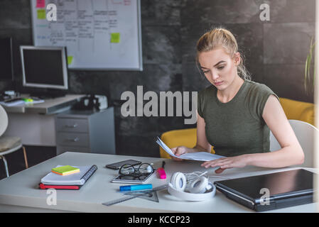 Junge Geschäftsfrau Schreibarbeit zu tun im Büro Stockfoto