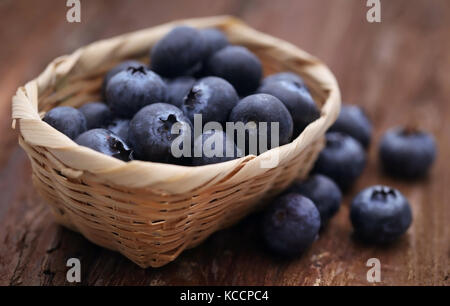 Gruppe von frischen Blaubeeren in einem Korb auf natürliche Oberfläche Stockfoto