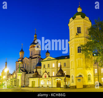 Wunderschöne Aussicht auf die Kathedrale der Verklärung und Wasserturm von pochaev Lavra in Abend Leuchten, pochayev, Ukraine Stockfoto