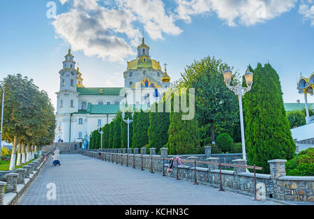 POCHAYIV, UKRAINE - 29. AUGUST 2017: Dormitio-Kathedrale von Pochayiv Lawra auf der Spitze des Hügels mit schöner Gasse, die zum Eingang führt Stockfoto