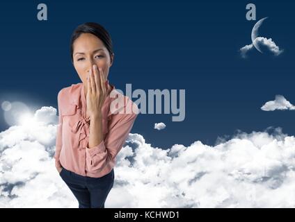 Digital composite von Frau gähnen in Wolken mit Mond Stockfoto