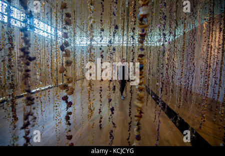 Die Künstlerin Rebecca Louise Law setzt den letzten Schliff für ihre neue Hängeinstallation "Life in Death" mit 375,000 Blumen in der Shirley Sherwood Gallery of Botanical Art, Teil von Artful Autumn in Kew Gardens im Südwesten Londons. Stockfoto