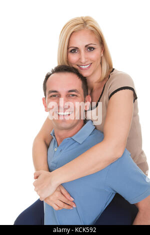 Junger Mann Huckepack Frau Over White Background Stockfoto