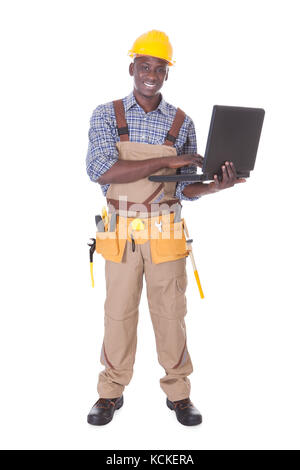 Mechaniker, die Eingabe auf Laptop Over White Background Stockfoto