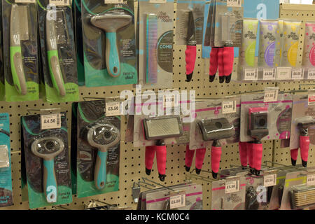 Eine Auswahl oder verschiedene Hund und Pet Grooming Tools auf Verkauf in eine große High Street Pet Supplies Business oder Einzelhändler. Kämme und Bürsten. Stockfoto