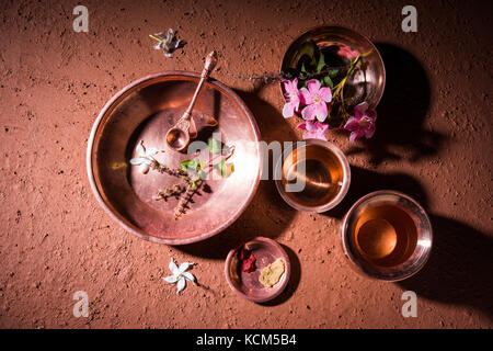 Kupfer Kalash, Glas, Löffel und Teller von bramhins nach Heiligen thread Zeremonie verwendet beim Durchführen von sandhya vandanam oder sandhya Kriya, über Lehm zurück Stockfoto