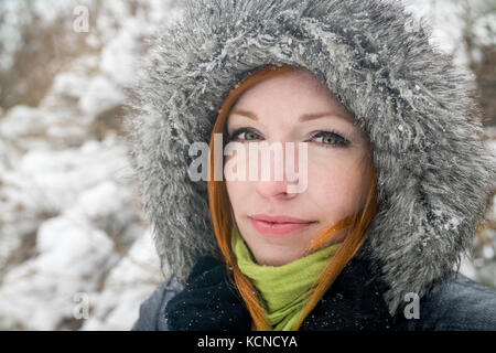 Frau (40) im Freien im Winter Schneefall. Stockfoto