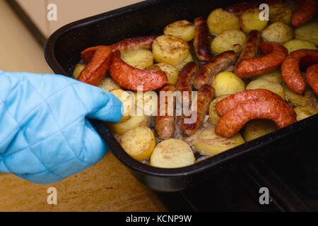 Frische heiße gebratene Würstchen und Kartoffeln aus dem Ofen Stockfoto