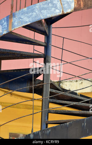 Eine bunte Wendeltreppe aus Metall, die wie ein helter-skelter mit kontrastierenden Farben und Formen. Stockfoto