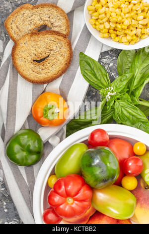 Gesunde Zutaten vermischen sich mit verschiedenen Arten von Tomaten, Paprika, Mais, Basilikum und apulische Brot frisella genannt. Stockfoto