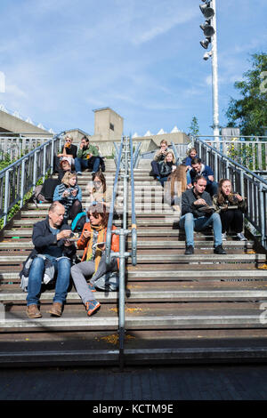 Die Menschen essen auf der Schritte außerhalb der Royal Festival Hall, South Bank Centre, London, SE1, UK Stockfoto