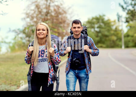 Ein junges Paar von Touristen Wanderer in die Wanderung auf der Straße Stockfoto