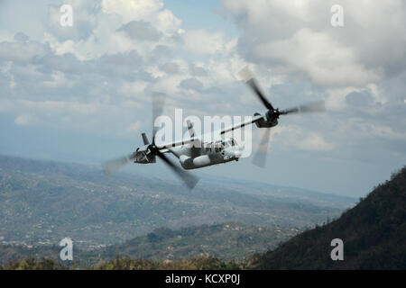 Ein U.S. Marine Corps V-22 Osprey fliegt über Rural Puerto Rico, 7. Oktober 2017, wie Sie trägt Mitglieder einer Delegation des Kongresses und seiner Mitarbeiter. Die Delegation bereist Puerto Rico die Schäden, die der Hurrikan Maria zu sehen und mit den Verantwortlichen von FEMA und seiner Partner zu sprechen. (U.S. Air Force Foto von Master Sgt. Joshua L. DeMotts) Stockfoto