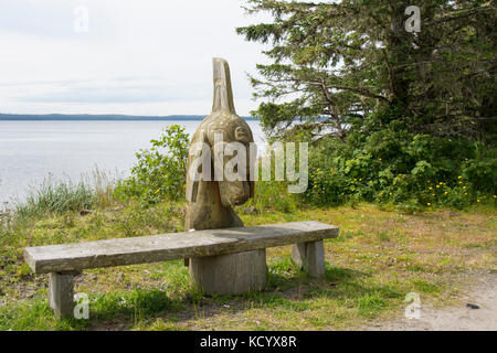 Rersting Sitzbank mit Haida Orca carving,, Alte Massett, Haida Gwaii, der früher als Queen Charlotte Islands, British Columbia, Kanada bekannt Stockfoto