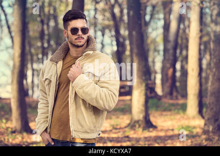 Stilvolle Mann mit Sonnenbrille im Herbst park Posing Stockfoto