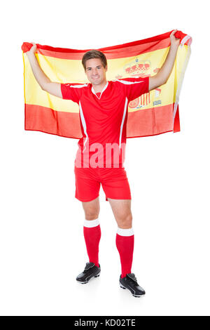 Fußball-Spieler, die mit der spanischen Fahne Over White Background Stockfoto