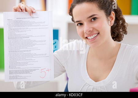 Glückliche Schülerin ihre perfekte Test angezeigt. Stockfoto
