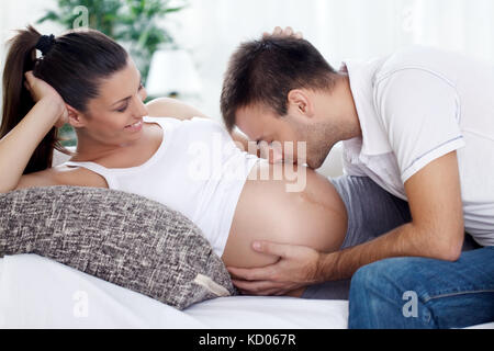 Zukunft Papa küssen Bauch seiner schwangeren Frau Stockfoto