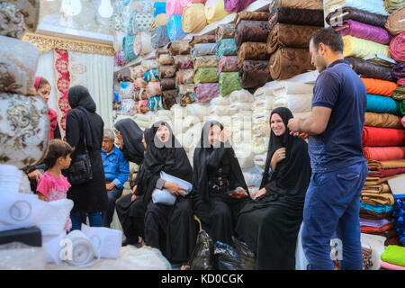 Provinz Fars, Shiraz, Iran - 19. April 2017: Mehrere iranische Frauen in Schwarz muslimische Kleidung Rest und Lachen in die Gewebe Abteilung des Zentralen ma Stockfoto