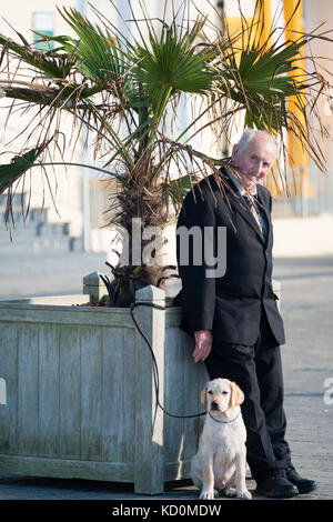 Aberystwyth Wales UK, Sonntag, 08. Oktober 2017 UK Wetter: Ein Mann und sein Hund am Meer in Aberystwyth Wales genießen einen wunderbar warmen und sonnigen Herbst am Sonntagnachmittag Foto: Keith Morris/Alamy Live News Stockfoto