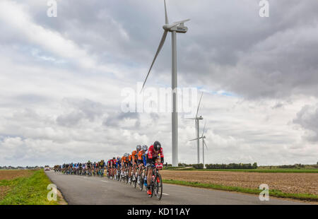 Le gault-saint-denis, Frankreich - Oktober 08, 2017: Das Peloton reiten auf einer Straße in der Ebene, in der Windmühlen in einem bewölkten Tag während der Paris-tours Straßen-Radrennen. Credit: Radu razvan/alamy leben Nachrichten Stockfoto