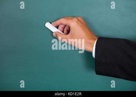 Nahaufnahme einer Hand schreiben auf der Schiefertafel Stockfoto