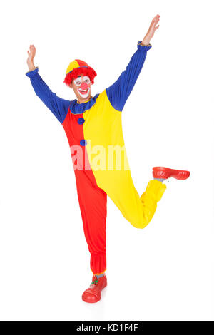 Porträt von Happy Joker Springen In Freude mit erhobener Hand Stockfoto