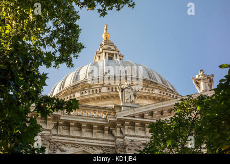 St. Paul's Cathedral Dome gesehen durch Bäume und Blätter auf dem Friedhof Garten. Stadt von London, Großbritannien Stockfoto