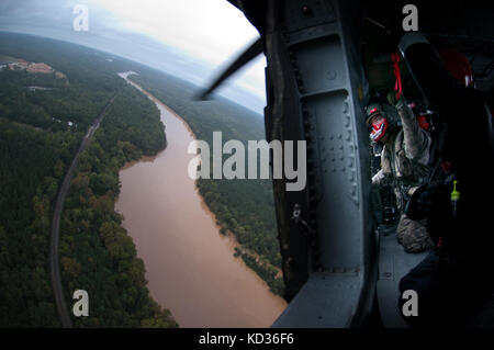 Südcarolina nationale Schutz UH-60 Black Hawk sc-Hart-Teams gemeinsam mit ihren Amtskollegen aus den North Carolina National Guard, der Suche und Rettung für Bürgerinnen und Bürger über Kolumbien durchführen, s.c., während der historischen Überschwemmungen okt. 5, 2015. Gebiete in den Midlands wurden mit mehr als zwei Fuß Regen, der verwüsteten viele Teile der Stadt und der umliegenden Gemeinden betroffen. (U.s. Army National Guard Foto: Staff Sgt. Roberto Di Giovine/freigegeben) Stockfoto