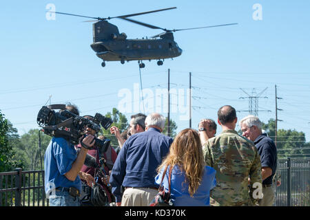 Herr W. Craig Fugate, Administrator der Federal Emergency Management Agency (FEMA) und Herr Kim Stenson, Direktor der South Carolina Emergency Management Division, beantworten die Fragen der Reporter während CH-47 Chinook Hubschrauber Operationen zur Stauung des durchbrechten Kanals am Riverfront Canal Park in Columbia, S.C., 7. Oktober 2015. Die South Carolina National Guard wurde aktiviert, um staatliche und County Notfallmanagement-Agenturen und lokale Ersthelfer zu unterstützen, da historische Überschwemmungen Grafschaften landesweit beeinflussen. Derzeit wurden mehr als 2,600 Mitglieder der South Carolina National Guard aktiviert i Stockfoto