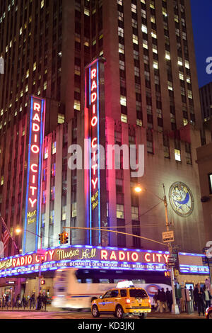 New York - 27. April: Nacht Verkehr sppeds Vergangenheit Wahrzeichen der Radio City Music Hall in New York City am 27. April 2015. Der Schauplatz ist legendär in entertainm Stockfoto