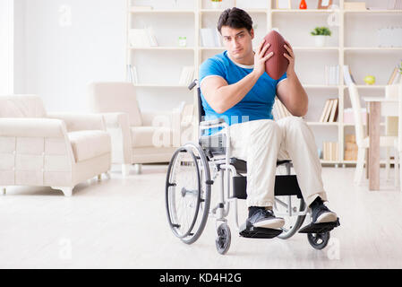 Junger Mann American football player Wiederherstellen auf Rollstuhl Stockfoto