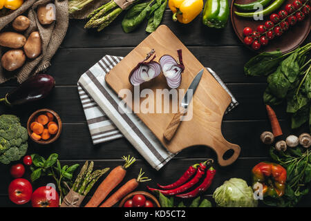 Schneidbrett mit Zwiebel und Messer Stockfoto