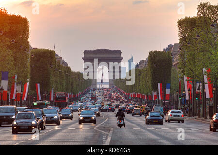 Paris (Frankreich): Avenue des Champs Elysees in Paris 8. Arrondissement/Bezirk. Verkehr, Französisch Fahnen und der Arc de Triomphe de l'etoile' (Triumph Stockfoto