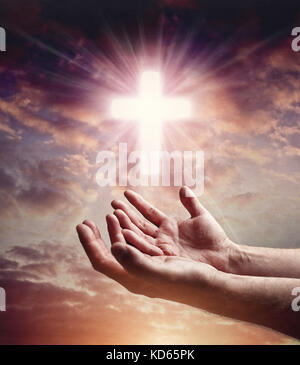 Hände, die mit dem Kreuz im Himmel nach Hilfe, Religion, Erlösung, Vergebung, Hilfe und Liebe oder Betteln greifen Stockfoto
